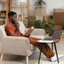man-planning-redecorating-home-using-laptop-book